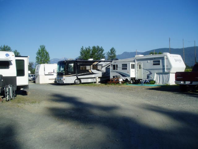 RVs hooked up at Royalwood with mountain backdrop
